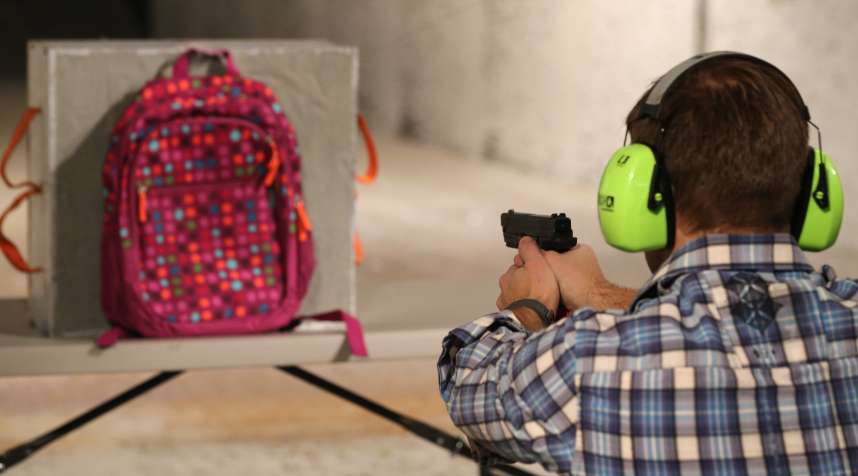 Chief Operating Officer for Amendment II, Rich Brand, shoots a child's backpack with their Rynohide CNT Shield in it