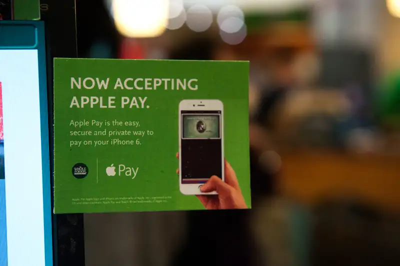 Apple Pay is promoted on signs placed at the cash register of Whole Foods in Columbus Circle on October 20, 2014 in New York, NY. T