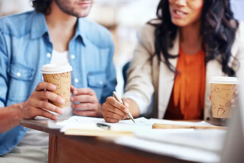 coworkers having coffee in coffee shop