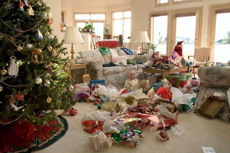 living room filled with wrapping paper from unwrapped presents