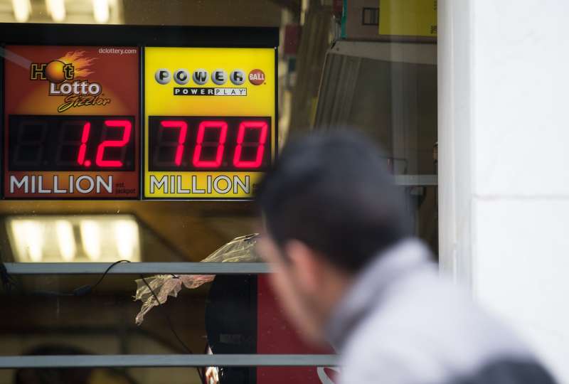 A sign in the window of a liquor store shows the Powerball lottery jackpot at $700 million in Washington, DC, on January 7, 2016.