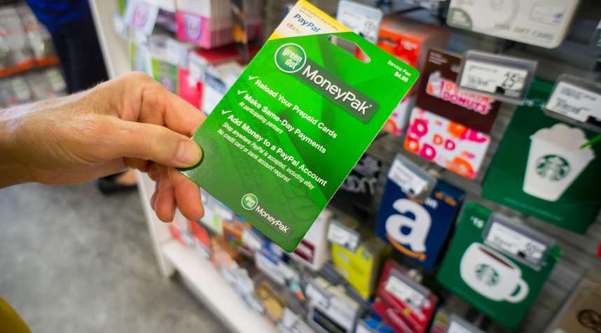 A shopper chooses a Green Dot brand MoneyPak prepaid card in a store in New York, August 1, 2014.