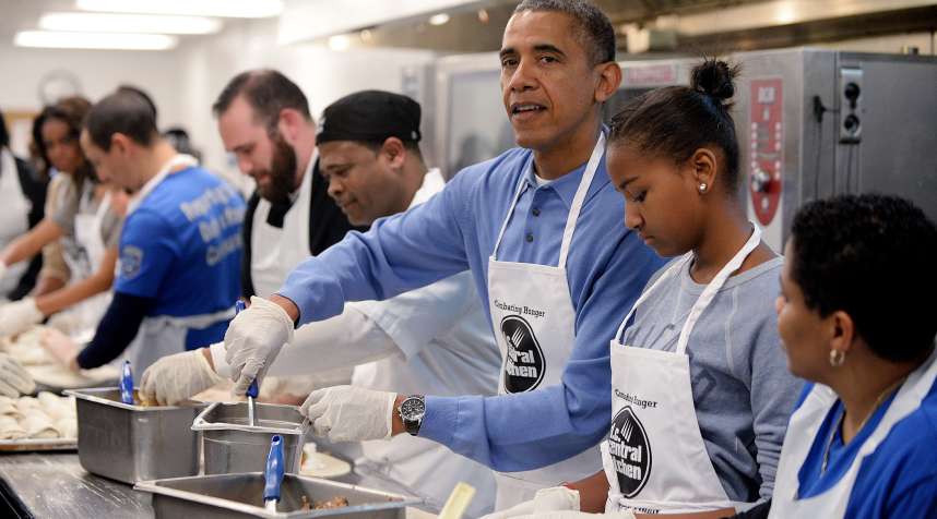 U.S. President Barack Obama with daughter Sasha and First Lady Michelle Obama (L) participate in a community service project at the D.C Central Kitchen in celebration of the Martin Luther King, Jr. Day of Service and in honor of Dr. King's life and legacy on January 20, 2014 in Washington, D.C.