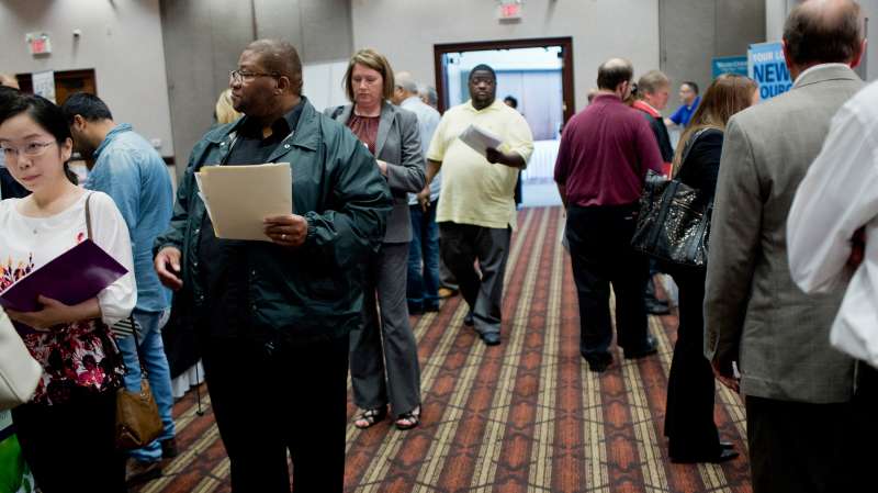Job seekers attend a Job Fair Giant career fair in Sterling Heights, Michigan, on September 30, 2015.