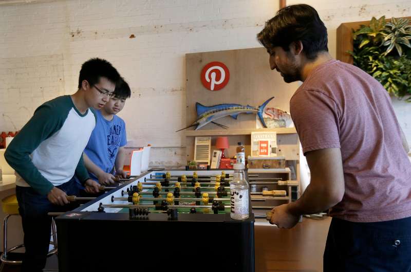 Pinterest software engineer interns play foosball in the office in San Francisco, April 1, 2015.