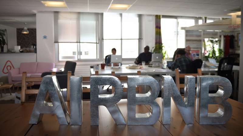 Employees of online lodging service Airbnb work in the Airbnb offices in Paris on April 21, 2015.