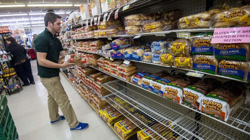 Bridgewater College junior communication major Jonah Barnhart, of Culpepper, Virginia, a floor stocker at Bridgewater Foods, races against shoppers stocking up before this weekend's snow storm to keep the bread aisle as full as possible for customers on January 20, 2015, in Bridgewater, Virginia. Heavy snowfall that's predicted to arrive by the weekend from Appalachia to Philadelphia and maybe farther north.