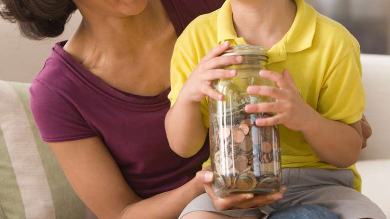 mother and son with jar of coins