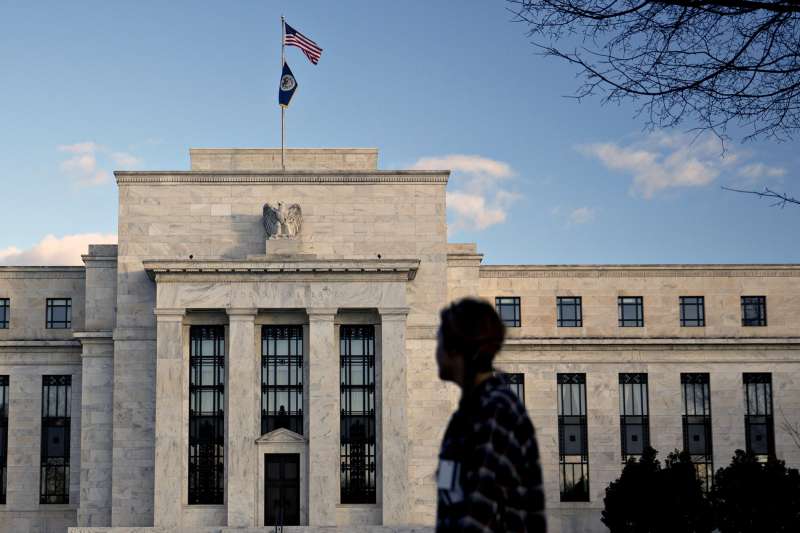A pedestrian walks past the Marriner S. Eccles Federal Reserve building in Washington, D.C., on December 15, 2015.