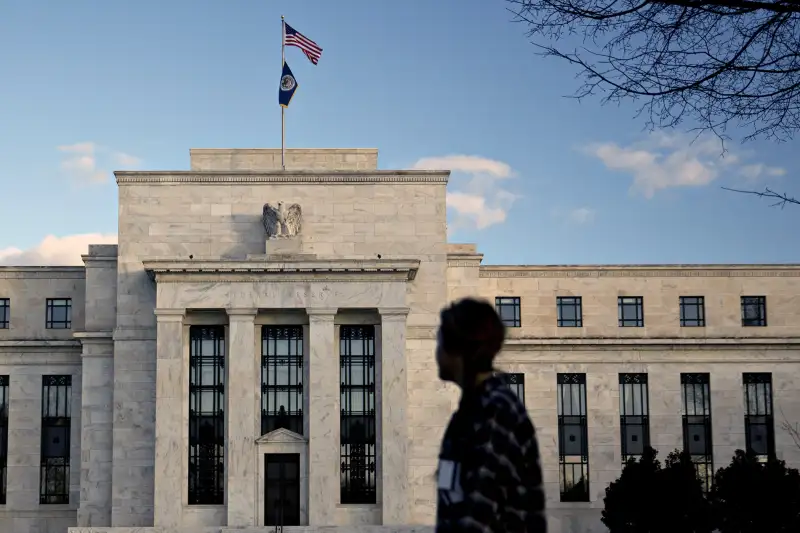 A pedestrian walks past the Marriner S. Eccles Federal Reserve building in Washington, D.C., on December 15, 2015.