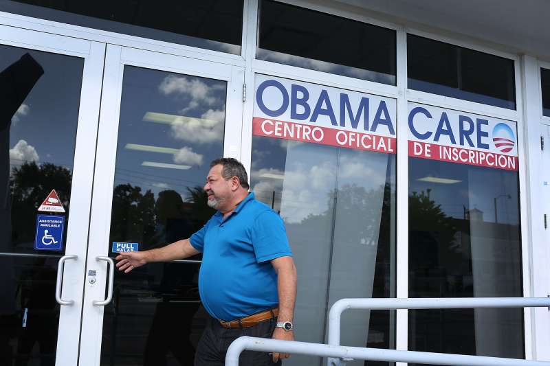 A person walks into the UniVista Insurance company office where people are signing up for health care plans under the Affordable Care Act, also known as Obamacare, on December 15, 2015 in Miami, Florida.