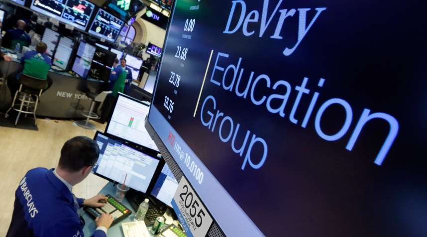 Specialist Neil Gallagher works at the post that handles DeVry Education Group, on the floor of the New York Stock Exchange, January 27, 2016. The government is suing the operators of the for-profit DeVry University, alleging they misled consumers about students' jobs and earnings prospects.