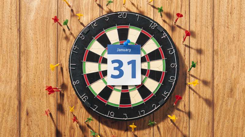 dartboard with January 31 calendar page in middle, dart boards hitting wall and missing target