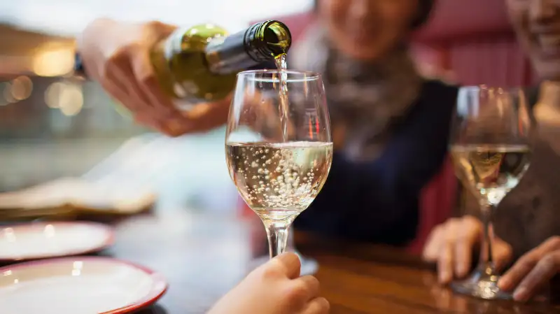 woman pouring wine