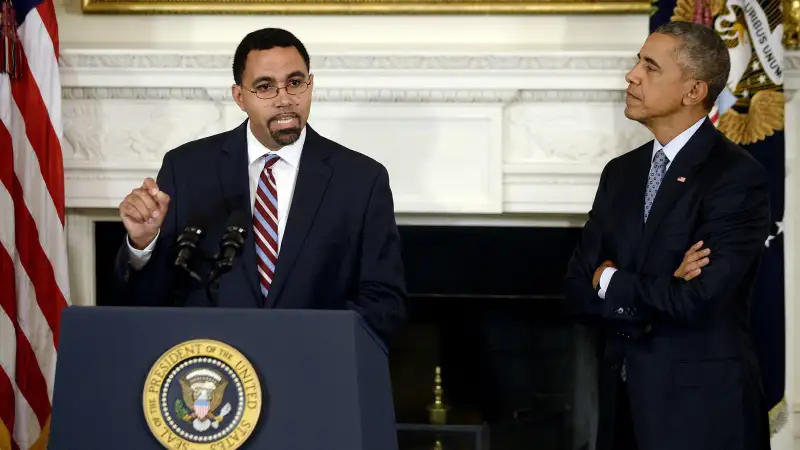 Deputy Education Secretary John B. King Jr. (L) delivers remarks after being nominated by U.S. President Barack Obama (R) to be the next head of the Education Department in the State Dining Room at the White House October 2, 2015 in Washington, DC.