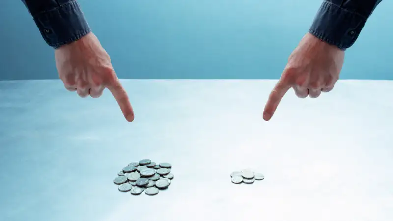 hands pointing at different piles of coins