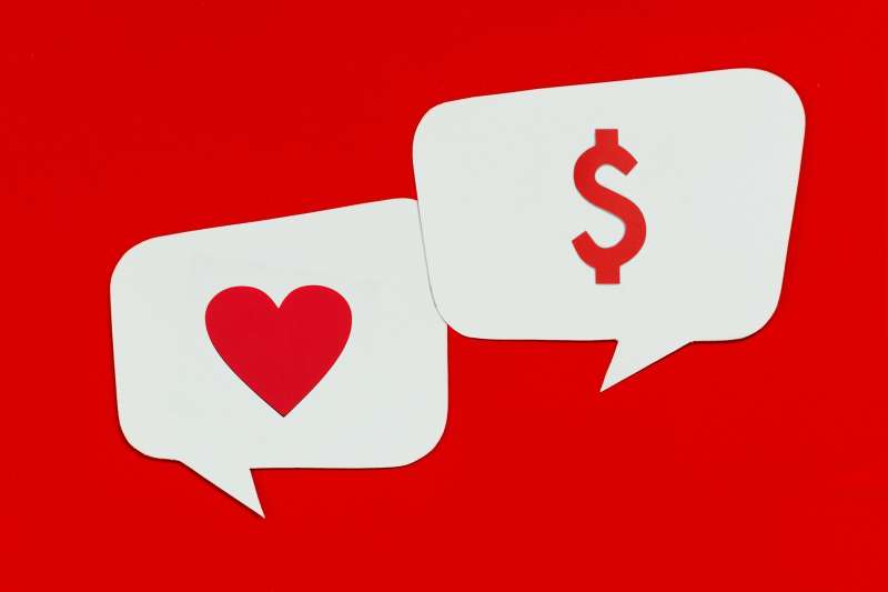 speech bubbles with heart and dollar sign made out of cut paper