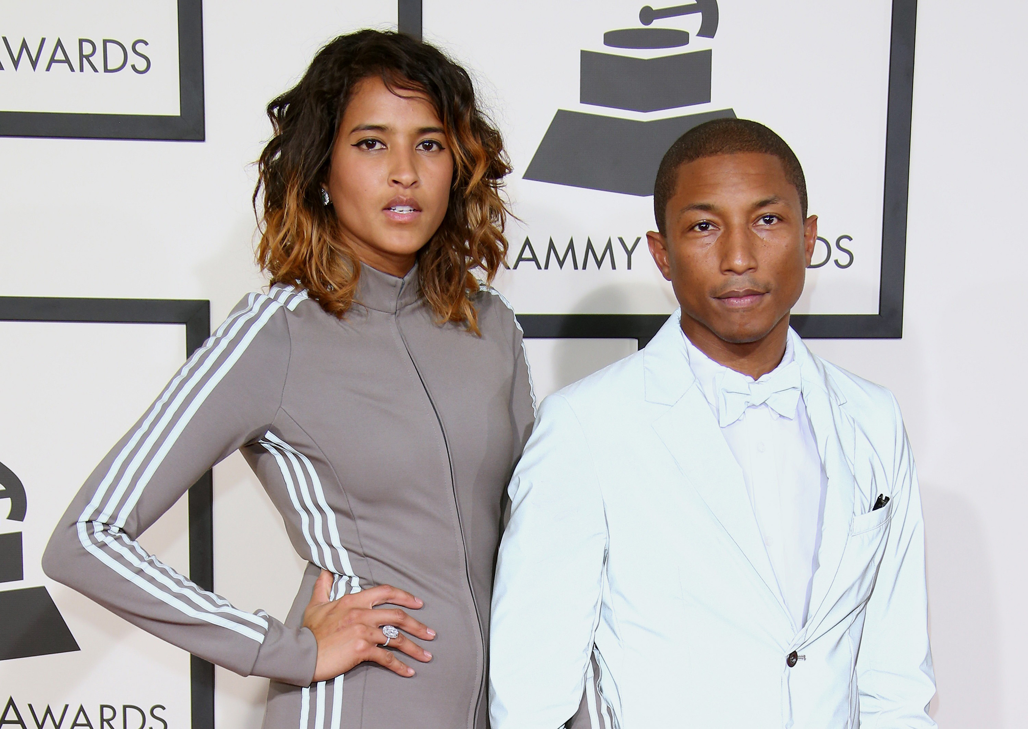 (L-R) Helen Lasichanh and Pharrell Williams attend The 57th Annual GRAMMY Awards at the STAPLES Center on February 8, 2015 in Los Angeles, California.