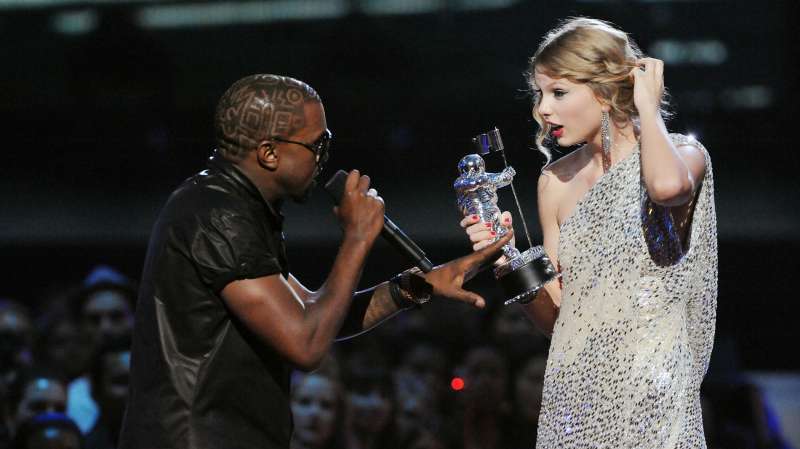 Kanye West (L) jumps onstage as Taylor Swift accepts her award for the  Best Female Video  award during the 2009 MTV Video Music Awards at Radio City Music Hall on September 13, 2009 in New York City.