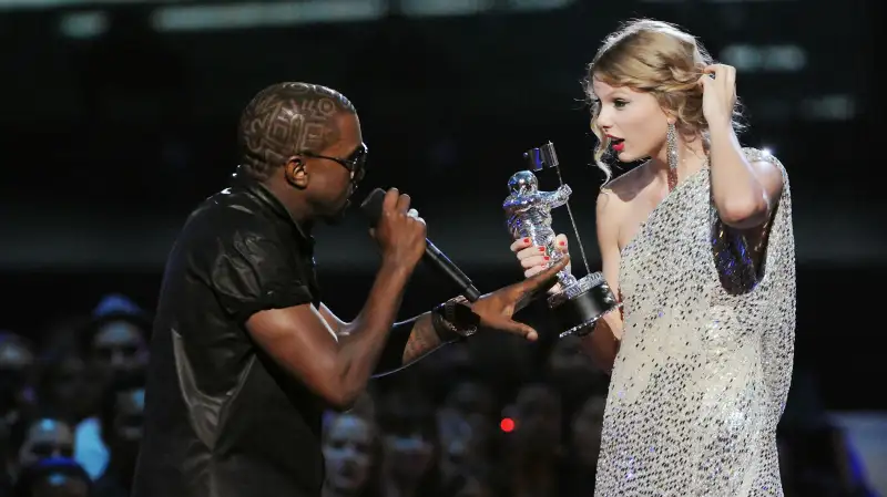 Kanye West (L) jumps onstage as Taylor Swift accepts her award for the Best Female Video award during the 2009 MTV Video Music Awards at Radio City Music Hall on September 13, 2009 in New York City.