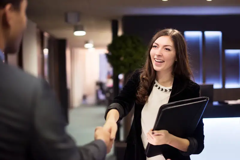 young woman shakes hands with her potential new boss