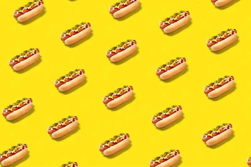 Hot dogs on yellow background