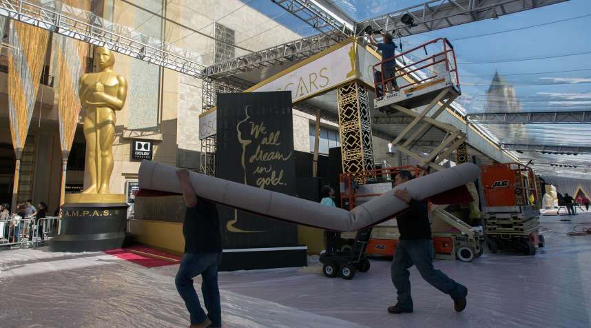 Workers prepare the red carpet arrival area on Hollywood Boulevard for the 88th Annual Academy Awards at Hollywood &amp; Highland Center on February 25, 2016 in Hollywood, California.