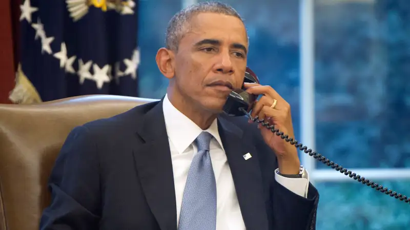 President Obama Works In The Oval Office Of White House