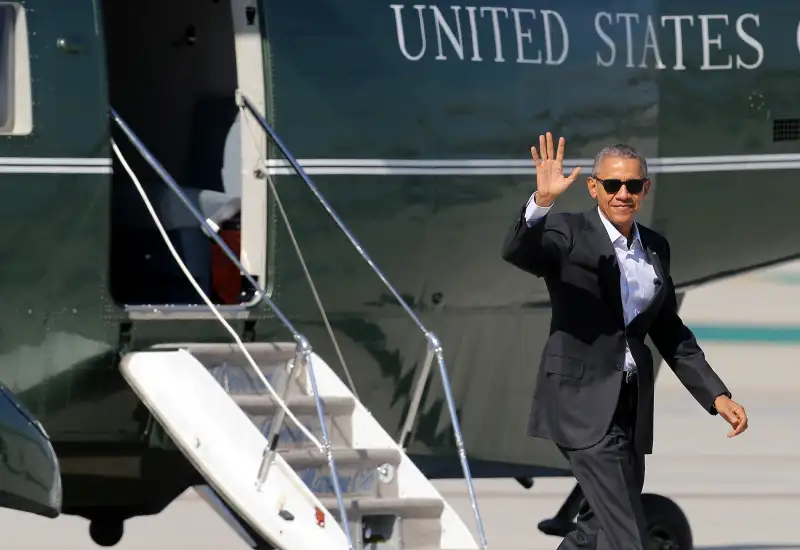 President Barack Obama waves to the assembled press as he arrives at Los Angeles International Airport aboard Marine One on February 12, 2016.