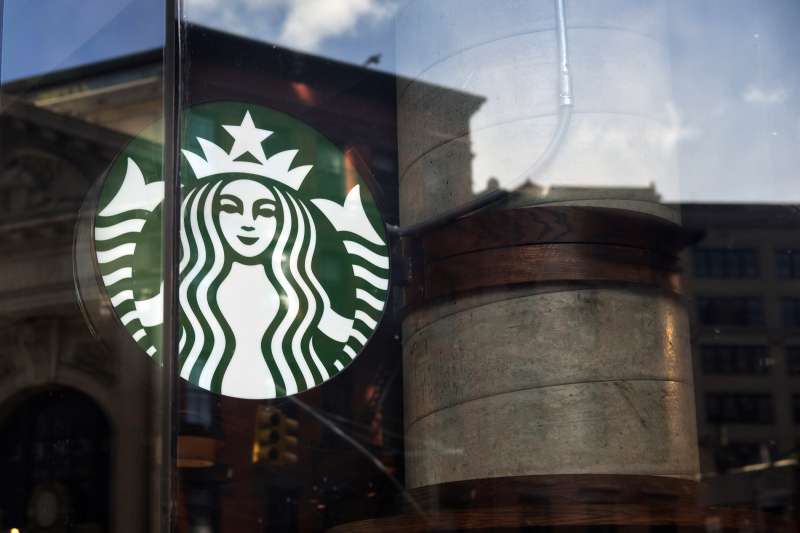 A Starbucks logo is displayed in the window of a coffee shop in New York, U.S., on January 17, 2016.