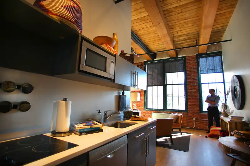 The factory 63 micro-housing apartments on Melcher Street in Fort Point, South Boston, February 13, 2013. The kitchen looking into the living room of a 530 sq. foot apartment.