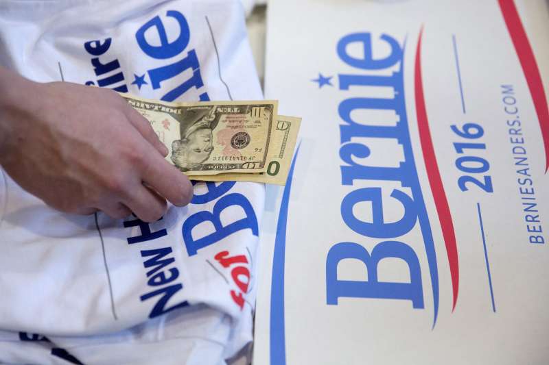 A campaign volunteer for Senator Bernie Sanders, an independent from Vermont and 2016 Democratic presidential candidate, handles contribution money from a supporter before Sanders, not pictured, speaks at a town hall meeting at Timberlane Performing Arts Center in Plaistow, New Hampshire, U.S., on Sunday, Jan. 3, 2016. Sanders' presidential campaign on Saturday said it raised more than $33 million in final three months of 2015 with small contributions making up the majority of the donations.