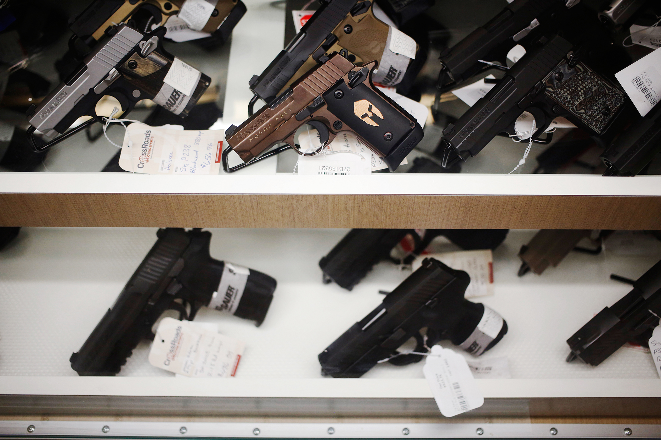 Handguns manufactured by SIG Sauer GmbH are displayed for sale during a campaign event for Donald Trump, president and chief executive of Trump Organization Inc. and 2016 Republican presidential candidate, at CrossRoads Shooting Sports in Johnston, Iowa, U.S., on January 30, 2016.