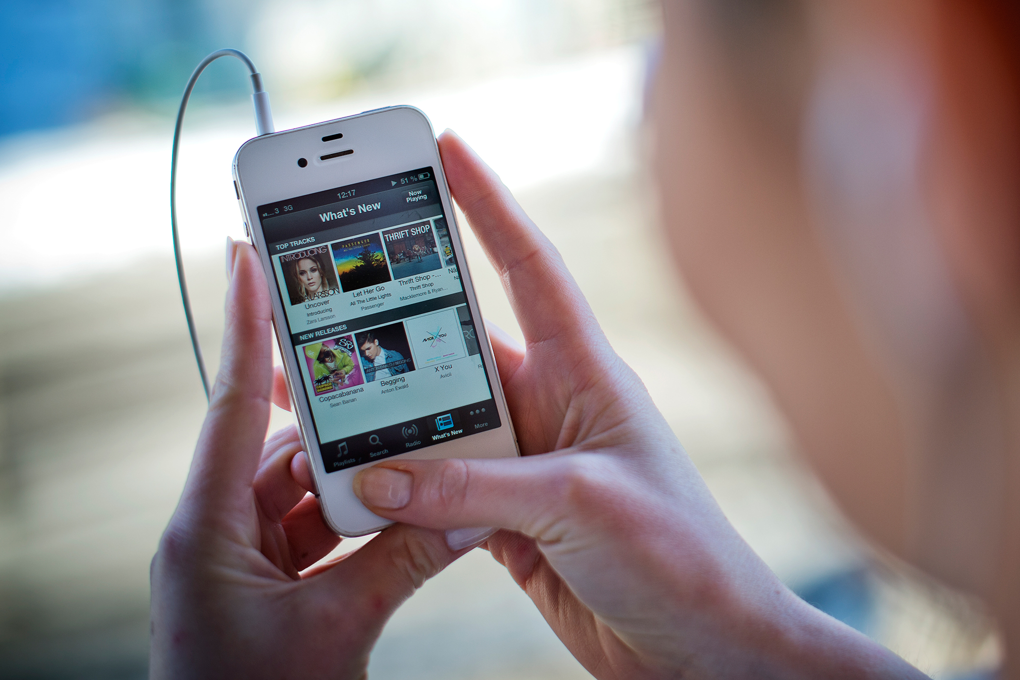 This photo shows a woman as she uses the iPhone application of Swedish music streaming service Spotify on March 7, 2013.