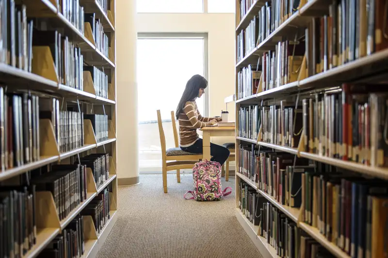 student in library