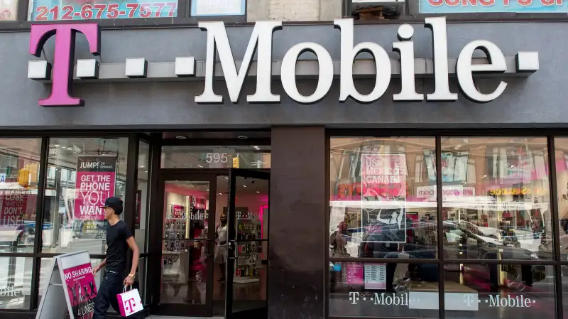 A customer exits a T-Mobile US Inc. store in New York, on July 26, 2015.