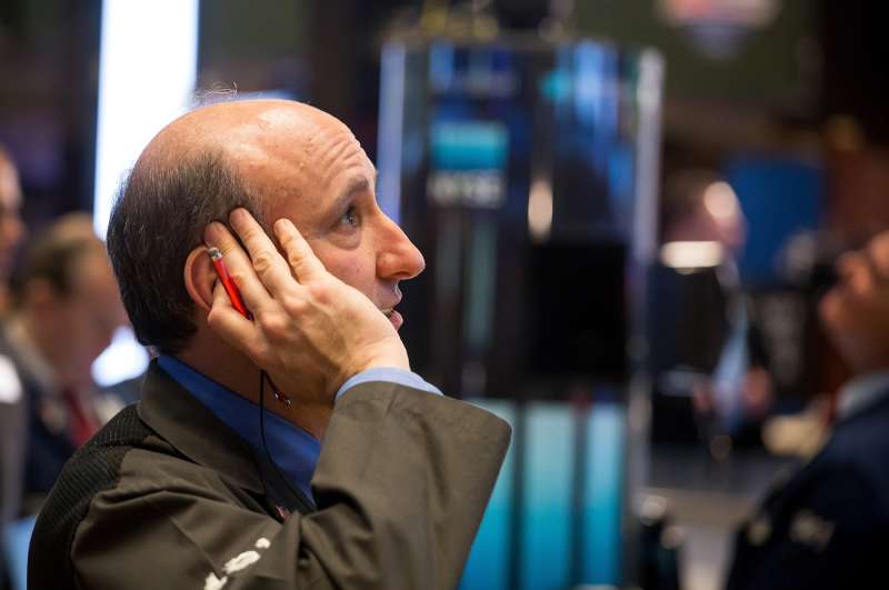 A trader works on the floor of the New York Stock Exchange (NYSE) in New York, U.S., on March 11, 2016.