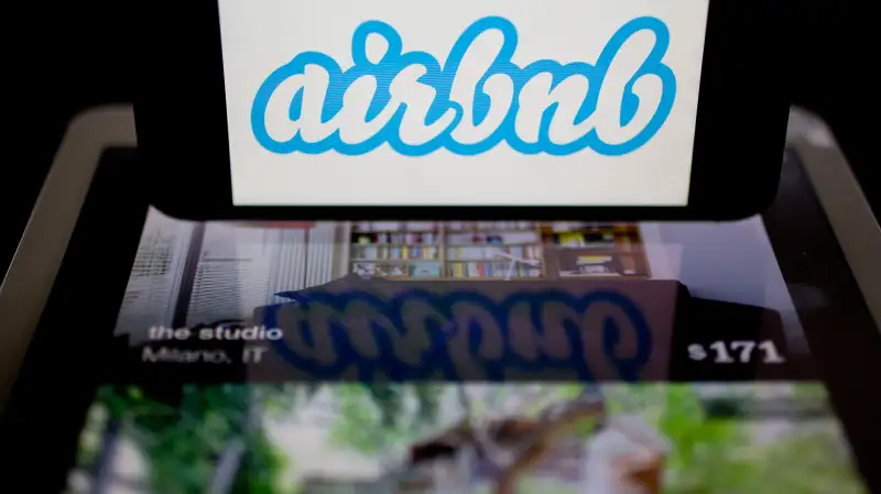 The Airbnb logo and application are displayed on an Apple iPhone and iPad in this arranged photograph in Washington, D.C., on March 21, 2014.