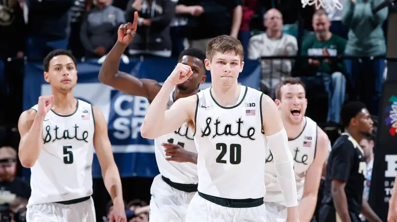 The Michigan State Spartans celebrate after defeating the Purdue Boilermakers in the championship game of the Big Ten Basketball Tournament at Bankers Life Fieldhouse on March 13, 2016 in Indianapolis, Indiana. Michigan State defeated Purdue 66-62.