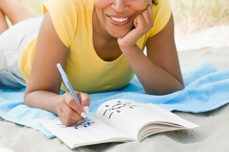 woman doing crossword puzzle