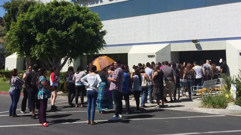 Students wait outside Everest College, Tuesday, April, 28, 2015 in Industry, Calif., hoping to get their transcriptions and information on loan forgiveness and transferring credits to other schools. Corinthian Colleges shut down all of its remaining 28 ground campuses on Monday, April 27, displacing 16,000 students. The shutdown comes less than two weeks after the U.S. Department of Education announcing it was fining the for-profit institution $30 million for misrepresentation.