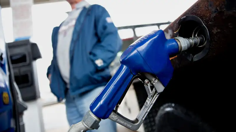 A customer fills up a vehicle with fuel at an Exxon Mobil Corp. gas station in Rockford, Illinois, on October 28, 2015.