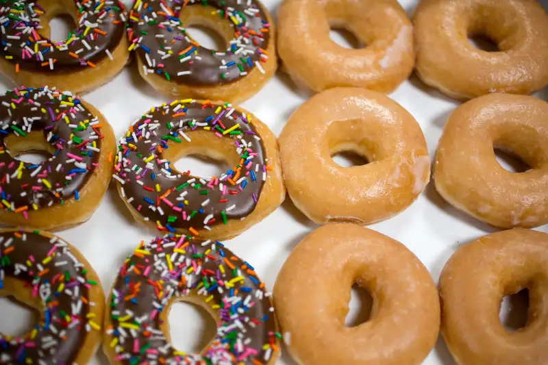 A box of Krispy Kreme Doughnuts Inc. doughnuts is arranged for a photograph in Washington, D.C., on June 17, 2013.