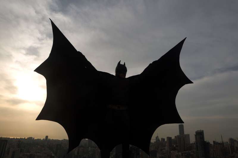TOPSHOT - A Lebanese model dressed as Batman plays on the rooftop of a building during a photoshoot in the capital Beirut on March 23, 2016.   / AFP / PATRICK BAZ        (Photo credit should read PATRICK BAZ/AFP/Getty Images)