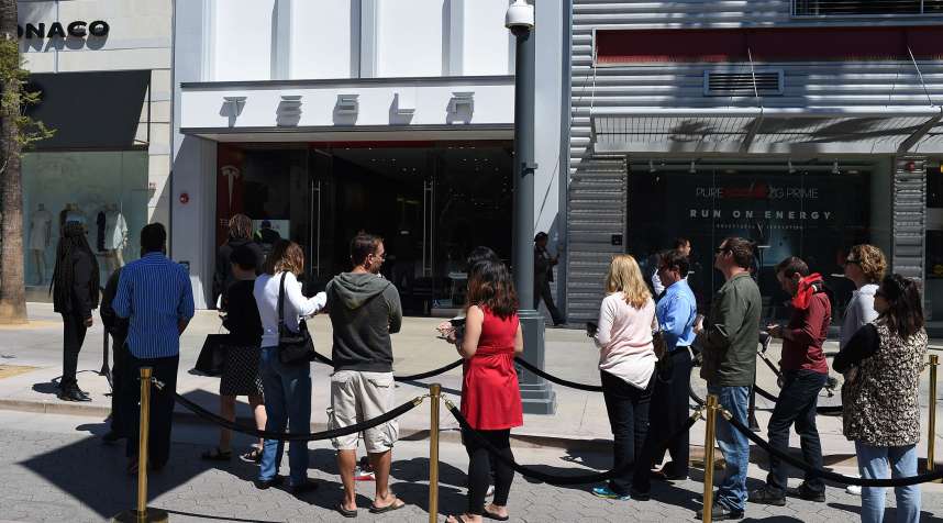 Customers waited outside Tesla showrooms this week to put deposits on the new Model 3.