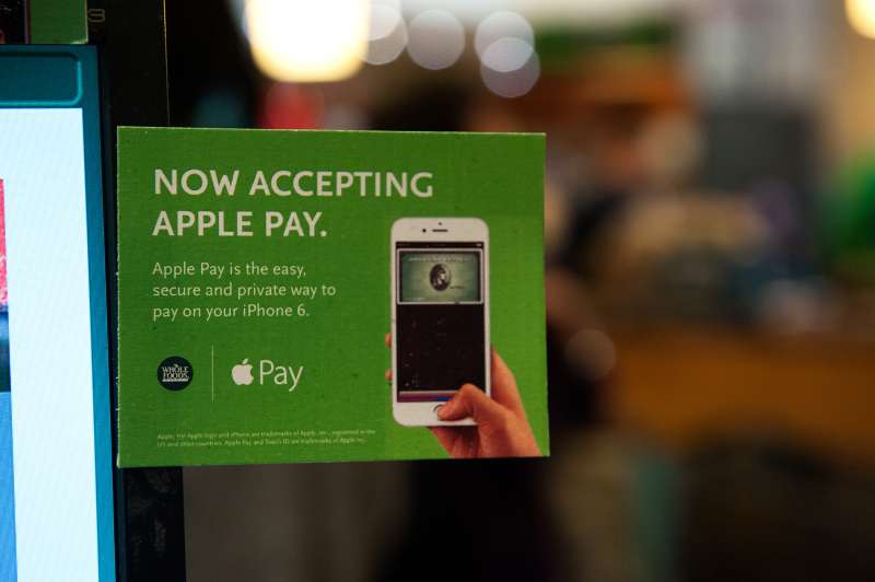 Apple Pay is promoted on signs placed at the cash register of Whole Foods in Columbus Circle on October 20, 2014 in New York, NY.