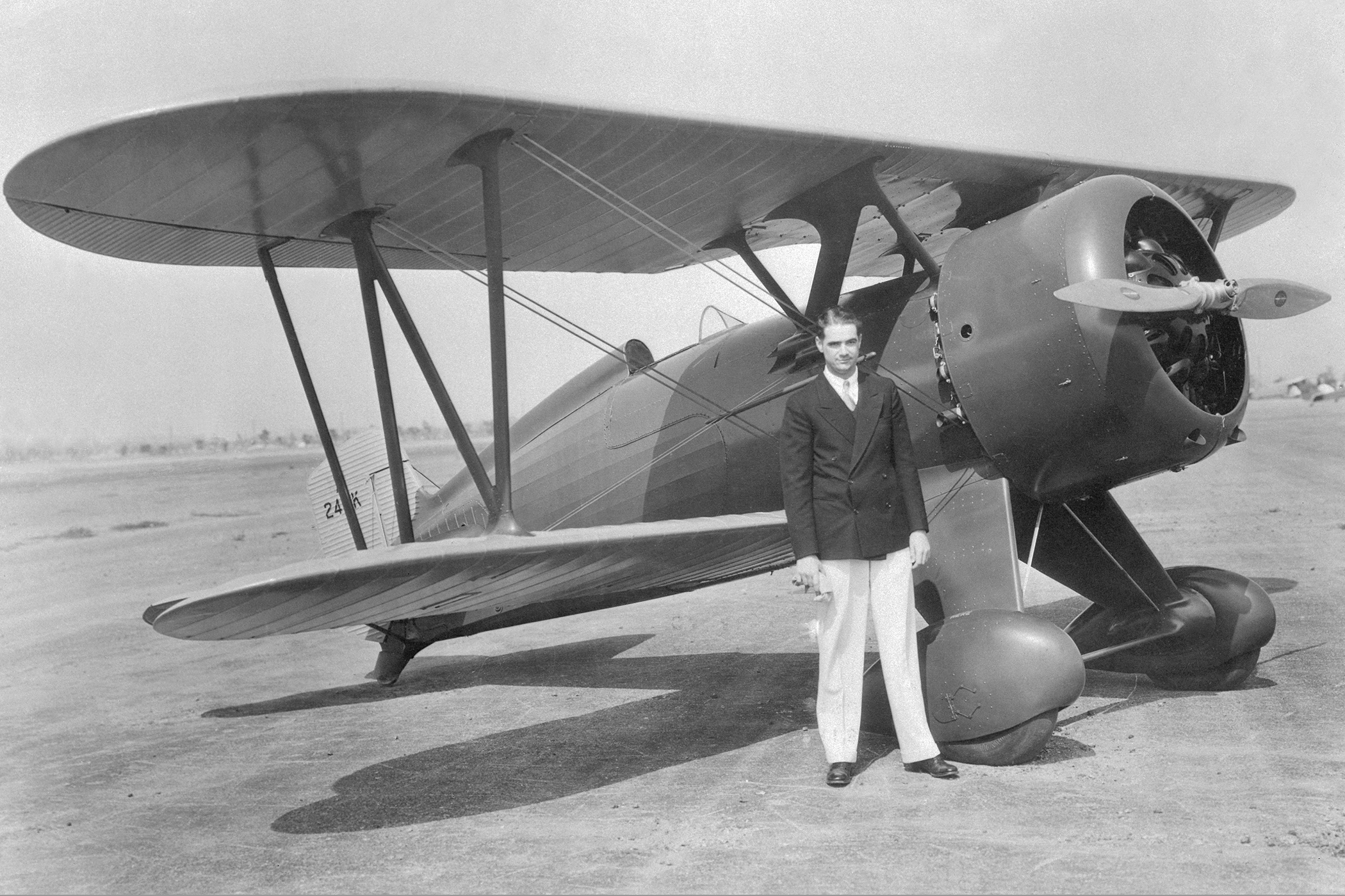 Howard Hughes, motion picture producer, shown after a test hop in his new high powered plane, a Boeing Army pursuit ship. Hughes is said to be the only private individual to own and pilot an Army plane.