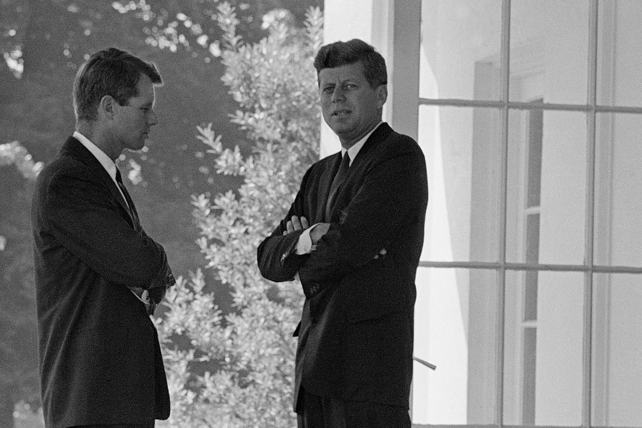 U.S. President John F. Kennedy, right, confers with his brother Attorney General Robert F. Kennedy at the White House in Washington, D.C., on Oct. 1, 1962 during the buildup of military tensions between the U.S. and the Soviet Union that became Cuban missile crisis later that month.