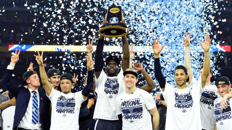 Villanova Wildcats forward Daniel Ochefu hoists the national championship trophy with teammates after defeating the North Carolina Tar Heels in the championship game of the 2016 NCAA Men's Final Four at NRG Stadium, April 4, 2016.