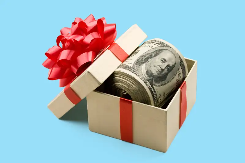box filled with roll of cash with bow on it